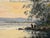 Original watercolor on paper depicting a tranquil river or marsh landscape at sunset, with reflective water, reeds, mature...