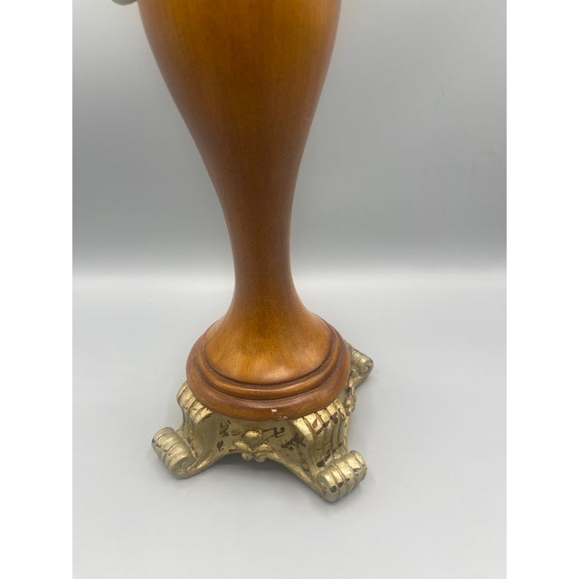 Striking vintage candleholder featuring a beautifully shaped warm wood body accented with ornate gold-tone metal...