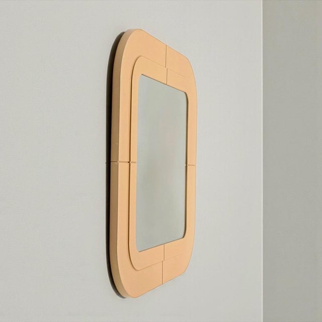 Vintage Kartell wall mirror with softly rounded square frame in beige ABS plastic. Made in Italy in the 1960s and...