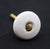 Vintage cabinet or drawer knob made of white ceramic with a round shape. A mounting screw is included. Good condition with...