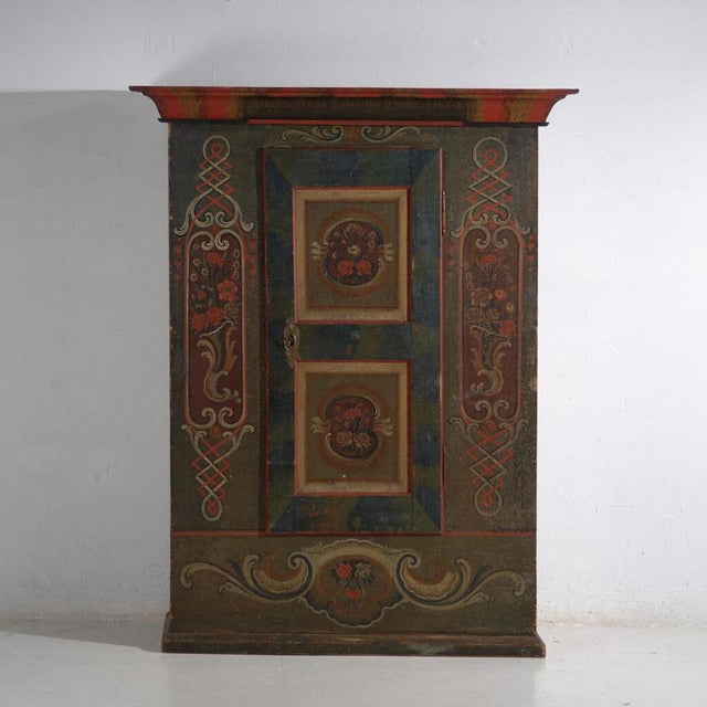 Antique central european folk art cabinet made of solid pine wood and dated 1814, as indicated by the painted inscription...
