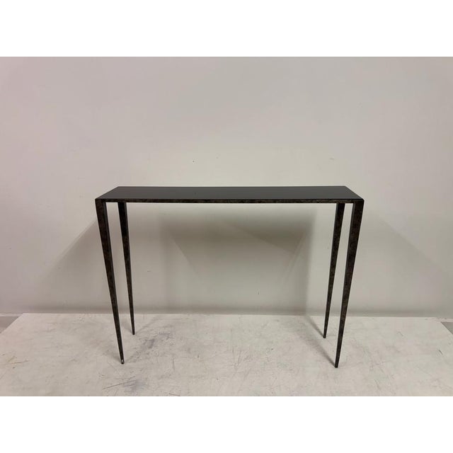 A refined forged steel console table, by Porta Romana, in the spirit of the understated modernism associated with Jean-...