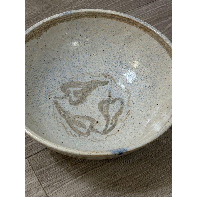 A beautifully crafted handmade studio pottery bowl, featuring a warm neutral glaze and a bold hand‑painted chile pepper...