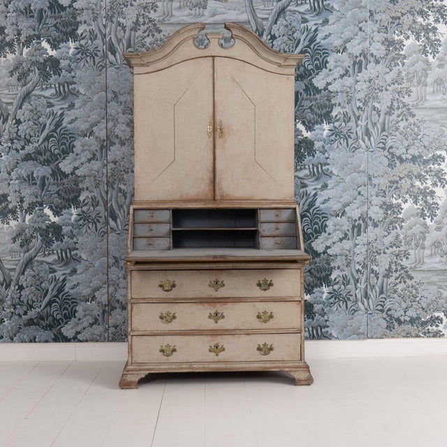 A Swedish slant-front secretary with library from the Gustavian period in two parts, circa 1790. A pediment top and upper...