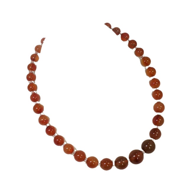 Vintage carnelian bead necklace 1950s. Graduated beads of smooth carnelian stones alternate with small faceted discs of...