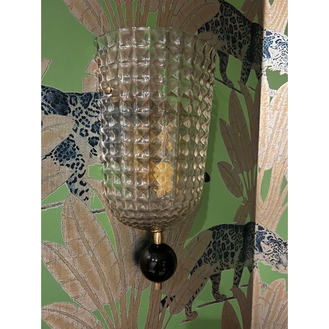 Fine pair of Art Deco style Murano glass sconces of “stampato” glass finished with a bottom black Murano glass and gilt...
