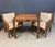A chic rattan game table and pair of matching lounge chairs, designed by Billy Baldwin for Bielecky Brothers. The set...