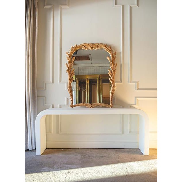 Hand-carved in Italy, this mid 20th century wheat stalk framed large wall mirror was created by Chelini Giovannini, a...