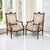 A pair of 19th century French Louis XVI armchairs, crafted of solid French walnut, carry the grace of the neoclassical age...