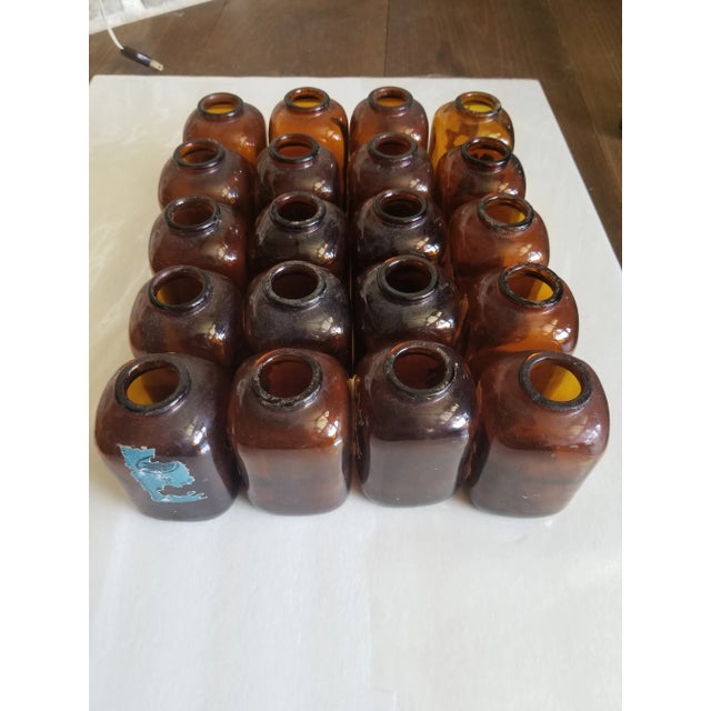 Collection of 20 antique amber colored snuff bottles. Some with remnants of their original labels and some with no...