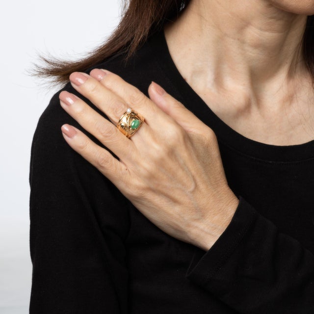 Stylish vintage jade & pearl wide band crafted in 18 karat yellow gold (circa 1970s). Cabochon cut jade measures 8.5mm x...