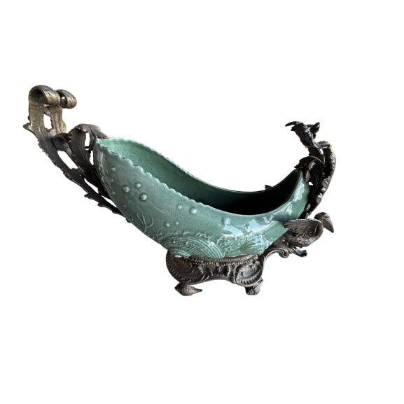 Materials & finish: The bowl itself appears to be crackled glazed ceramic or porcelain in a soft celadon / aqua green tone...