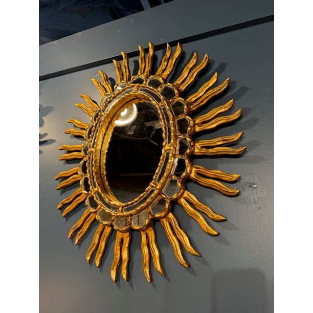 The Vintage Italian Giltwood Sunburst Mirror is a stylish and elegant addition to any room, perfect for those looking to...