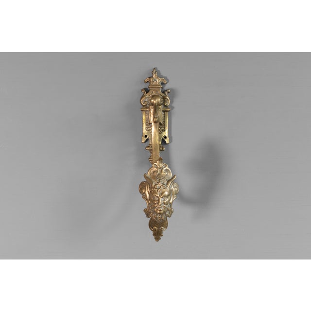 Decorative cast brass curtain hook. Circa 1900.