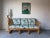 This vintage bamboo and rattan sofa, designed in the style of Ficks Reed, features a classic coastal and tropical...