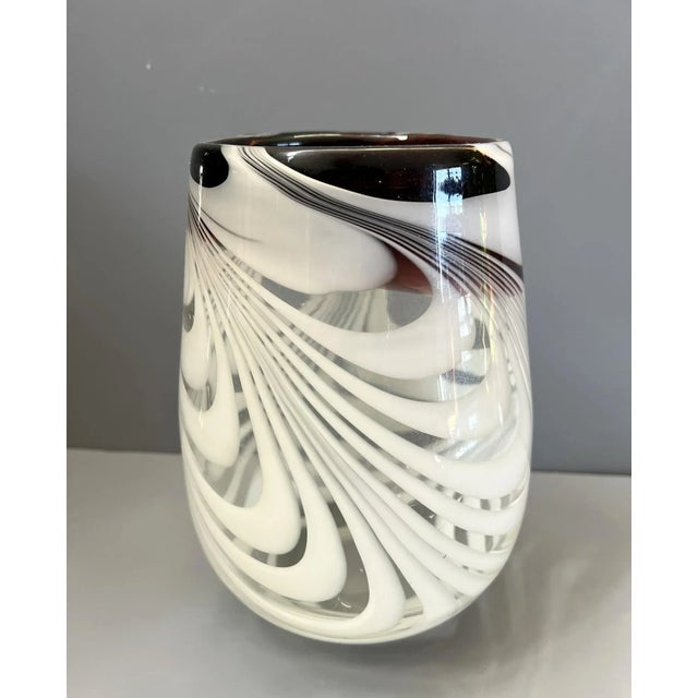 The object is beautiful hand blown glass vase with amethyst and white feathery swirls. Puntel visible on base. Wide mouth...