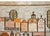 A beautiful mid-20th century Polish Folk Art Cepelia rug depicting a village with rows of houses and churches, and sylized...