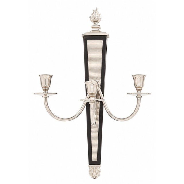 Elegant pair of American three-light wall sconces dating to the mid-20th century. These sophisticated sconces feature...