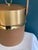 Designed by Georges Briard, this vintage ice bucket features a textured faux leather body paired with gold-tone metal...