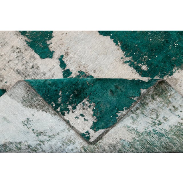 Beautiful hand-knotted vintage wool rug with a green field. This distressed rug has white accents featuring an all-over...