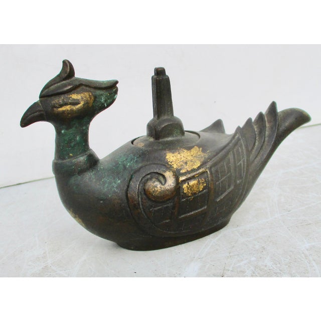 FUKUSUKE marked to the base. A classic mid-century image of the sitting Phoenix with gilt well and monumental form handle....