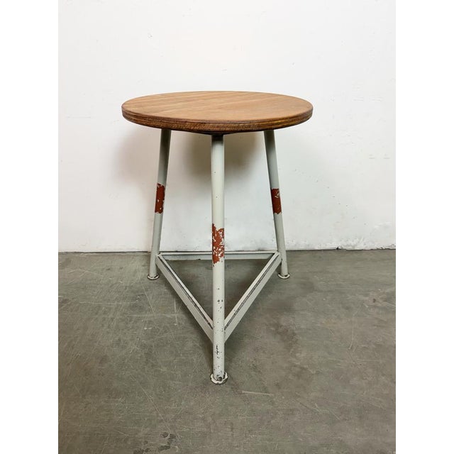 Vintage Industrial factory stool made in former Czechoslovakia during the 1960s It features a plywood seat and a grey...