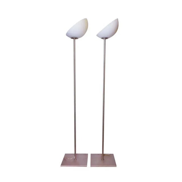 A pair of floor lights, blown glass white and yellow battuto technique shade on metal structure. Made in Italy. This piece...