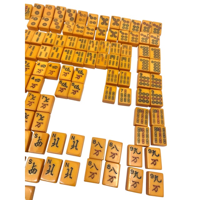 Vintage Bakelite butterscotch mahjong set. There are a total of 158 pieces. I can't confirm if this is a complete set. You...