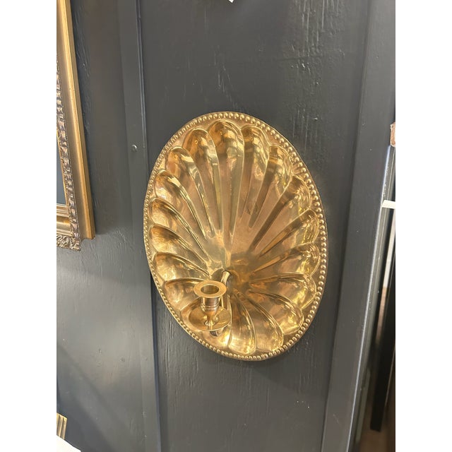 Pair of Vintage Brass Wall Sconces Pair of vintage brass wall-mounted candle sconces with a scalloped backplate and single...