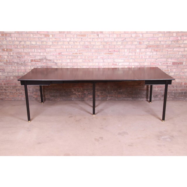 An exceptional mid-century modern Hollywood Regency extension dining table By John Widdicomb USA, 1950s Black lacquered...