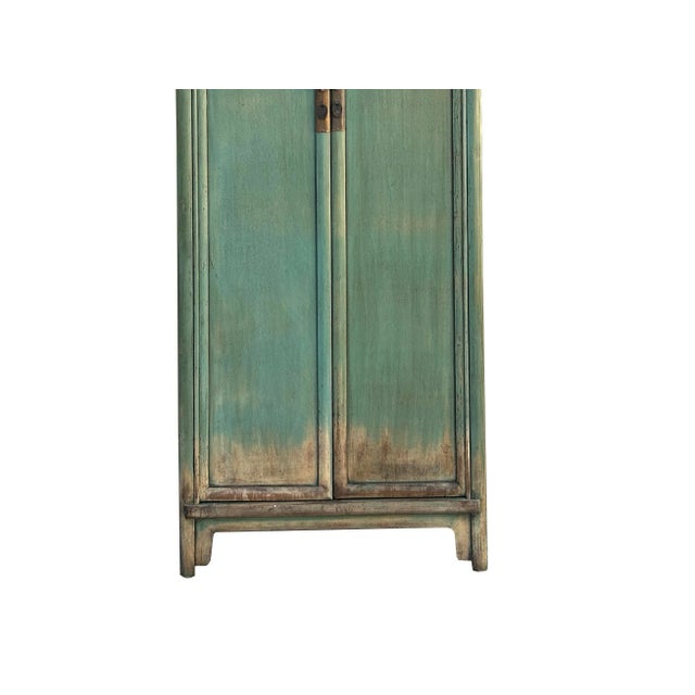Embrace the artistry of antique style with this striking Chinese-inspired cabinet, featuring a captivating distressed teal...