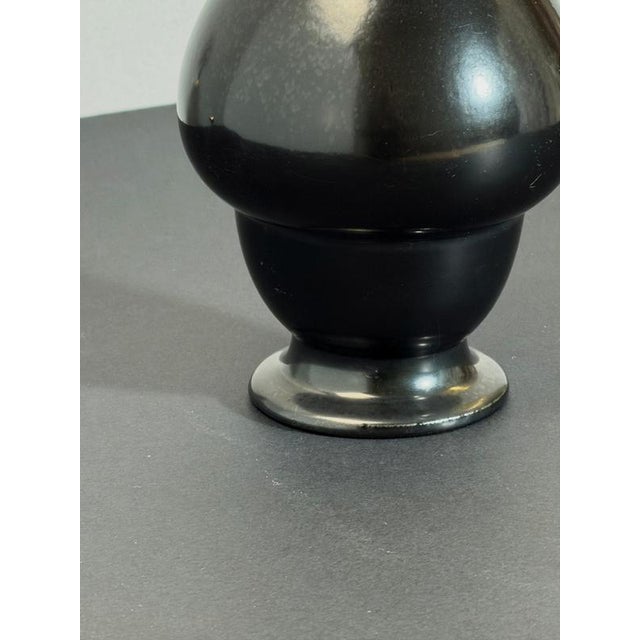 An unusual late Victorian black glazed earthenware vase by Wardle & Co., England, dating to the late 19th century....