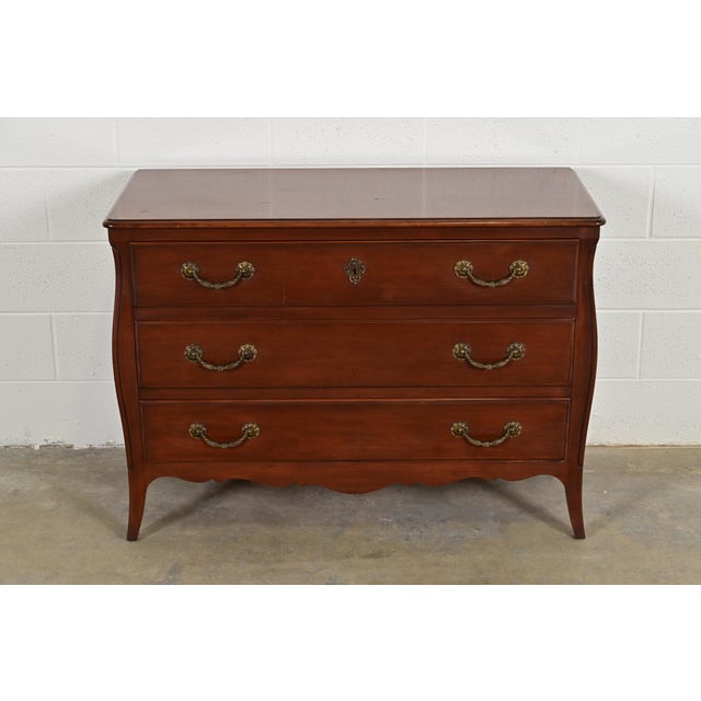 A gorgeous French Provincial Louis XV style three-drawer commode, dresser, or chest of drawers In the manner of John...