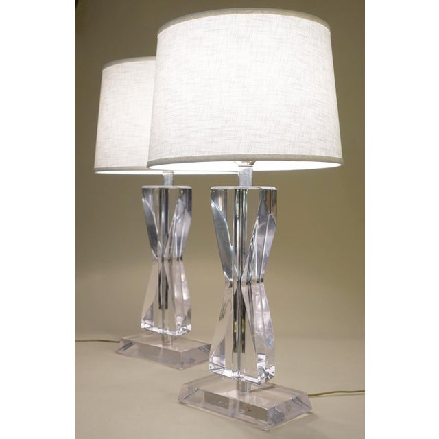 A dramatic and sculptural pair of Futuristic Modern "Hourglass" shaped super thick Lucite Acrylic lamps designed by...