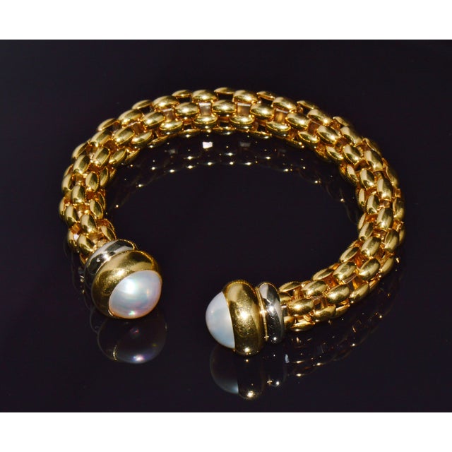 Authentic vintage FOPE Flex’it solid 18K gold pearl open cuff bangle bracelet. This gorgeous designer bracelet has a...