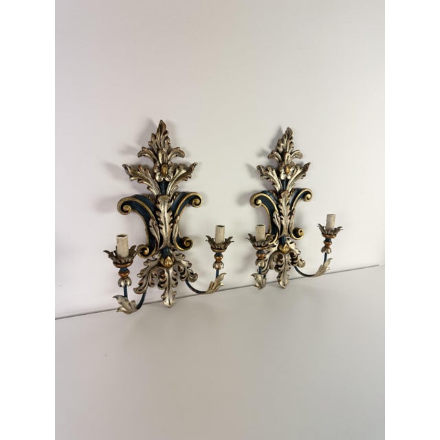 Set of two Florentine Palladio wall lamps, 1973 Handcrafted and numbered in lacquered wood and gold leaf, painted wrought...
