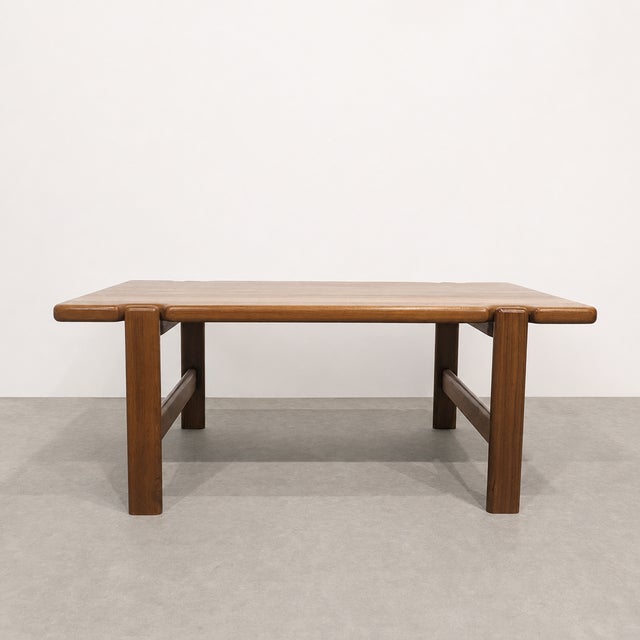 Solid teak coffee table in the style by Danish designer Niels Bach. The generously proportioned rectangular top is...