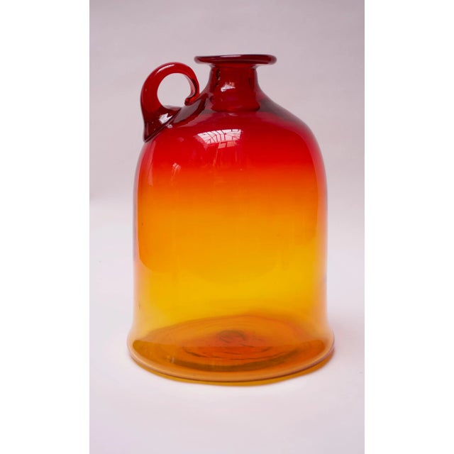 Blown glass jug designed by John Nickerson and manufactured by Blenko. This design first appeared in the 1972 Blenko...