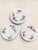 A beautiful set of three English fine bone china dessert plates by Roslyn, featuring delicate pink rose garlands accented...