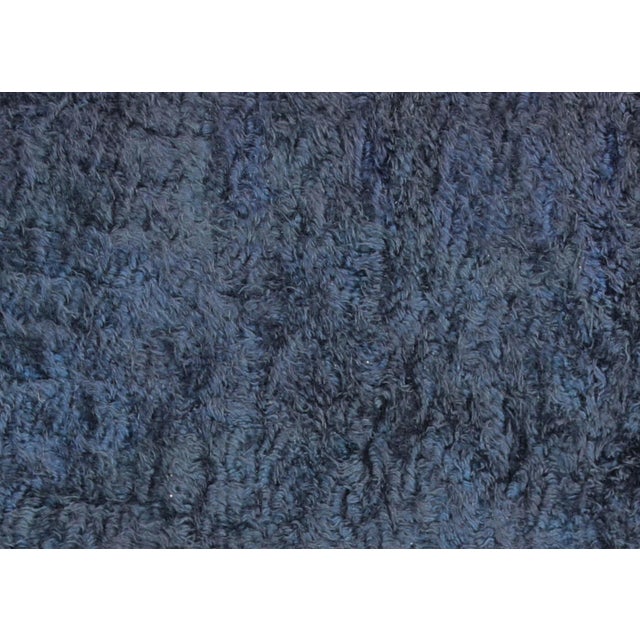 This vintage Turkish shag rug, measuring 6' x 7'11", is handwoven in the Oushak region of Western Turkey using a blend of...