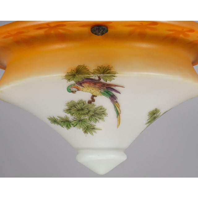 A large and fun period plafonnier shade made of cased opaline glass with a satin finish, a graduated orange ‘spritzdecor’,...