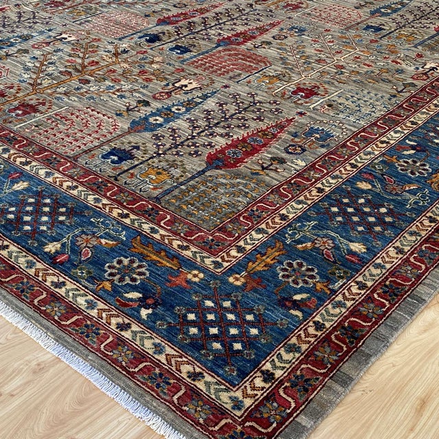 Fine Persian Bakhtiari Garden hand-knotted rug featuring a breathtaking all-over paradise garden composition set against a...