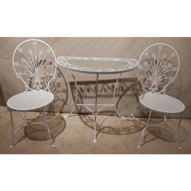 This is a most unique pair of mini wrought iron Peacock chairs en suite with a matching table. They are in the Hollywood...