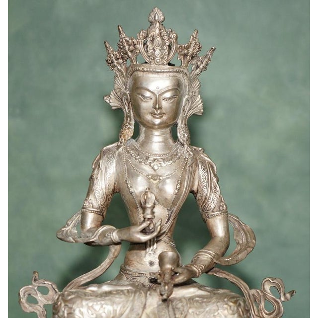 Tibetan Silvered Metal Buddhist Deity Figure on Lotus Base 20th Century An impressive and beautifully detailed Tibetan or...