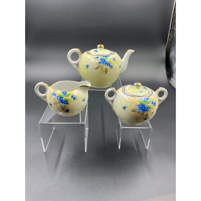 Beautiful Nippon three-piece tea set with hand painted forget-me-not design. Each piece has makers mark on the bottom -...
