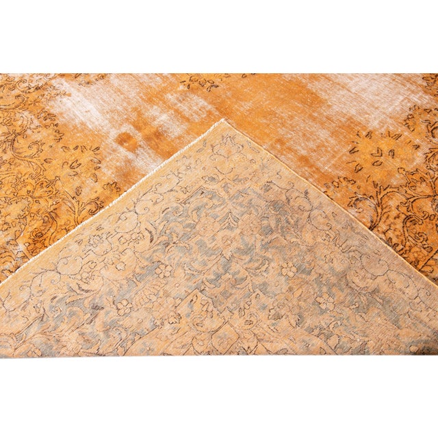 Beautiful Vintage overdyed hand-knotted wool rug with an orange color field. This Persian rug has gray accents in an all-...