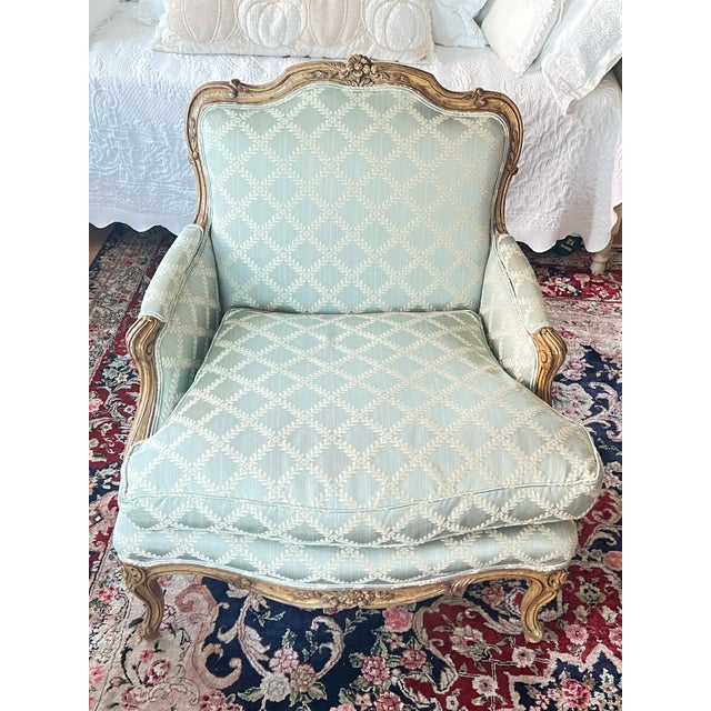 Elevate your interior decor with this elegant Pair of Early 1990s era Paint Decorated French Louis XV Bergere Chairs,...