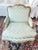 Elevate your interior decor with this elegant Pair of Early 1990s era Paint Decorated French Louis XV Bergere Chairs,...