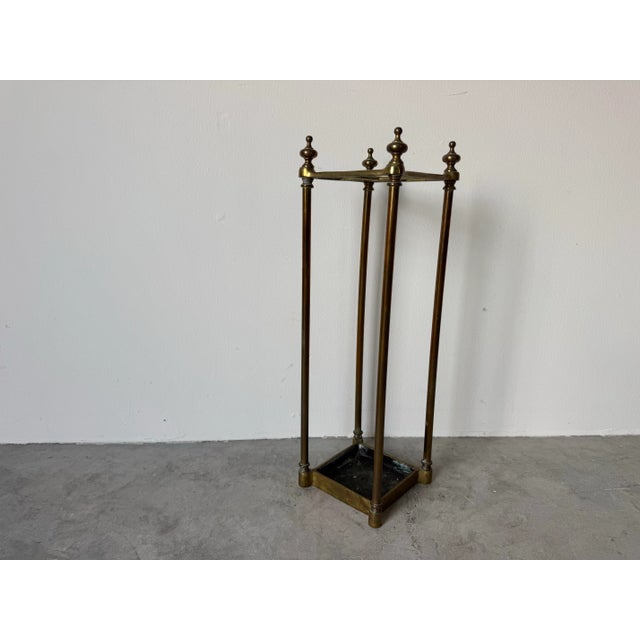 Charming vintage umbrella stand crafted from solid brass with classic finial-topped posts and elegant linear form. This...