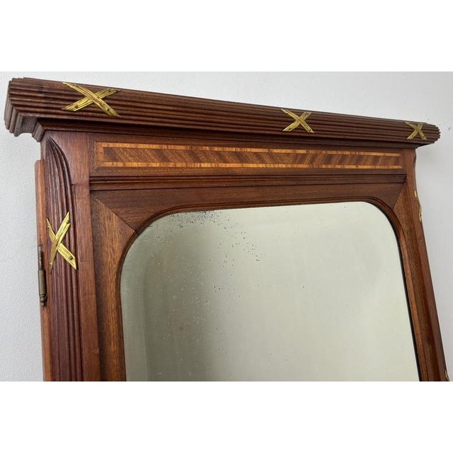 This elegant Antique French mirror is a beautiful decorative piece, featuring a refined walnut frame enhanced with...